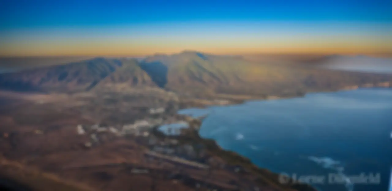 From about 8,000 feet, early morning, looking toward Kahului harbor and west Maui, with Molokai in the background . . .
