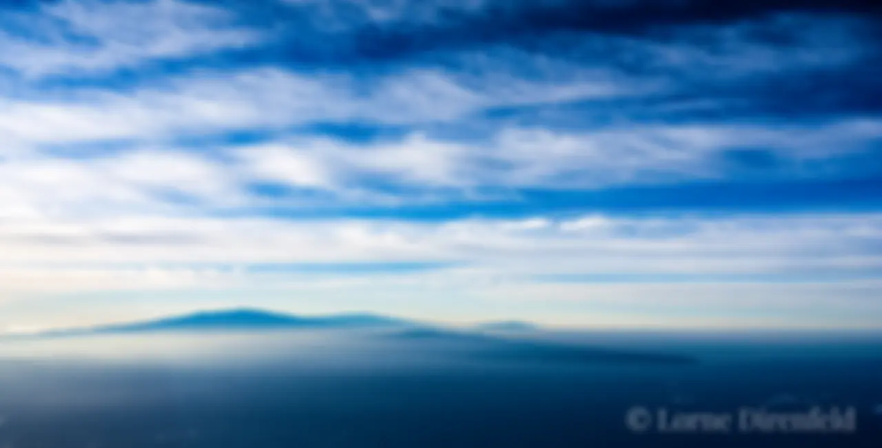 In the sky, looking south from Maui at about 9000 feet, towards the north end of the Big Island of Hawaii on a beautiful morning.