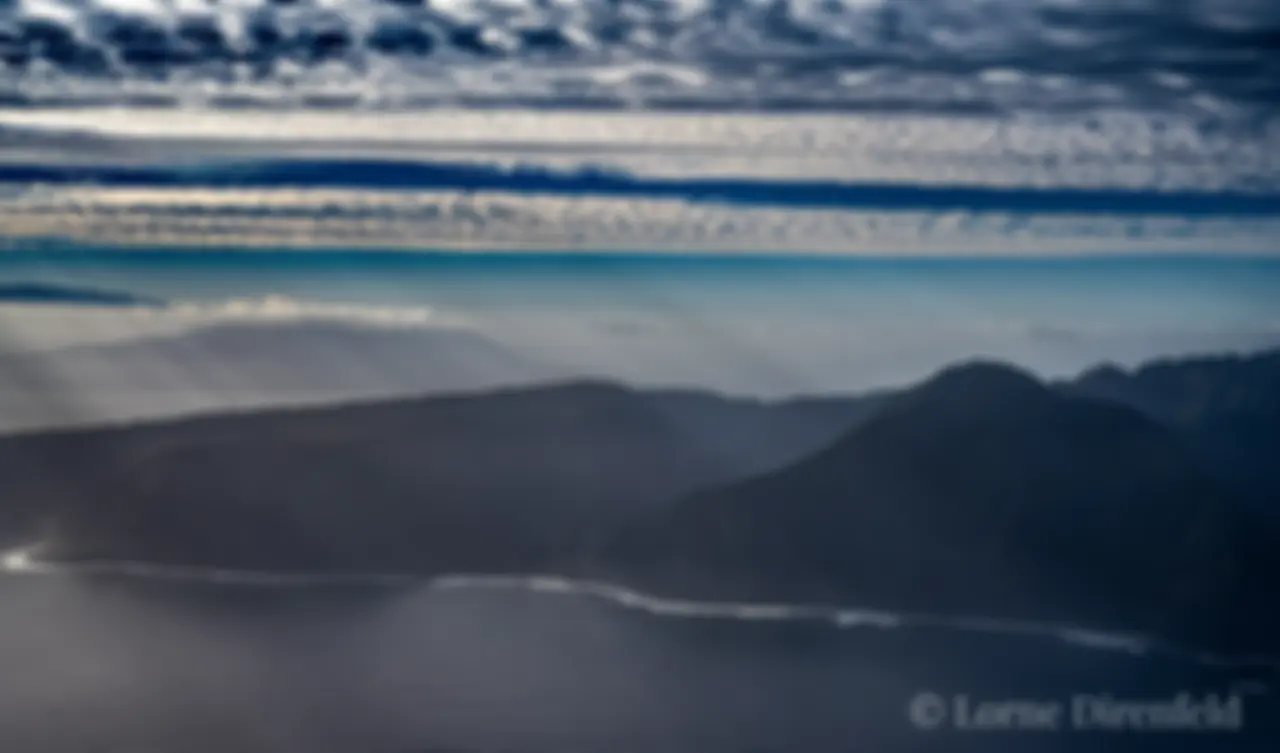 Molokai, north shore, tall sea cliffs in the early morning, with Maui in the background, upper left . . .