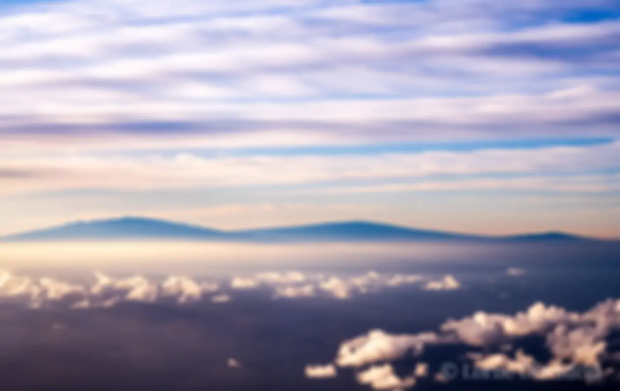 Mauna Kea, Mauna Loa and Hualalai mountains on the Big Island of Hawaii in the early morning . . .