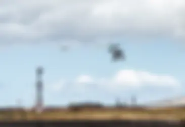 A tour helicopter departs ahead of a B737 on short approach to Runway 2 at Kahului airport . . .