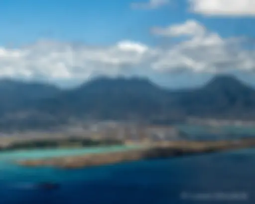 Coming in for landing, overflying the reef runway, as a ship leaves Pearl Harbor . . .