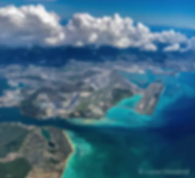 Looking down from 9000 feet, in the late morning at the Honolulu airport and the beautiful blue ocean . . .