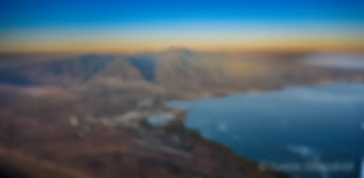 From about 8,000 feet, early morning, looking toward Kahului harbor and west Maui, with Molokai in the background . . .
