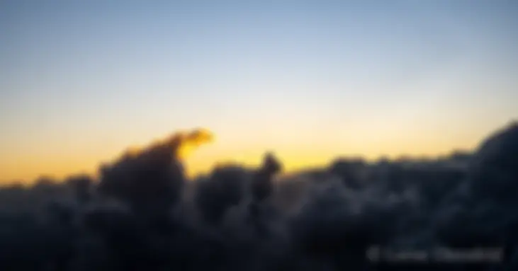 Departing Kahului, Maui, at dawn and climbing above the clouds . . .