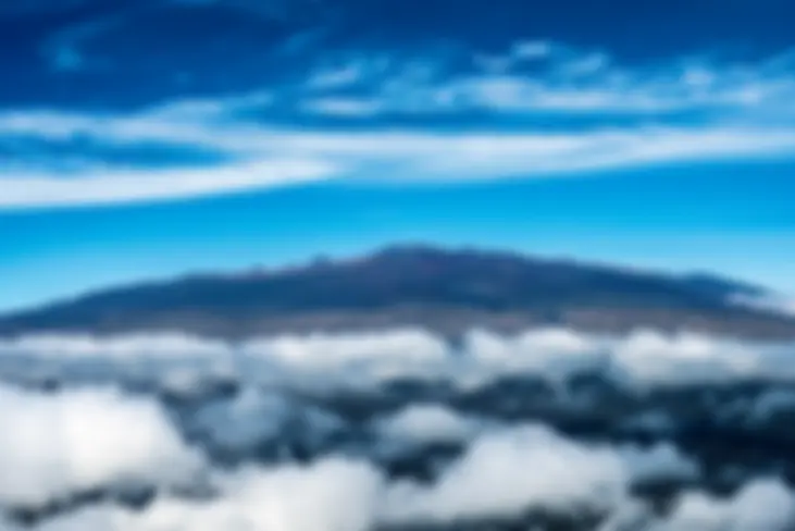 Mauna Kea on the Big Island of Hawaii, with observatories at the peak and wispy clouds above  . . .