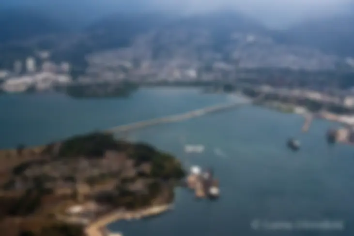 The bridge connects Ford island in Pearl Harbor to the mainland of Oahu . . . The Arizona Memorial can be seen just below the center of the image . . . The battleship Missouri is near the center lower part of the image . . .