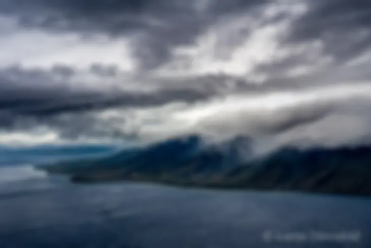 Clouds fill Oluwalu Valley and the wind is kicking up the waves . . .