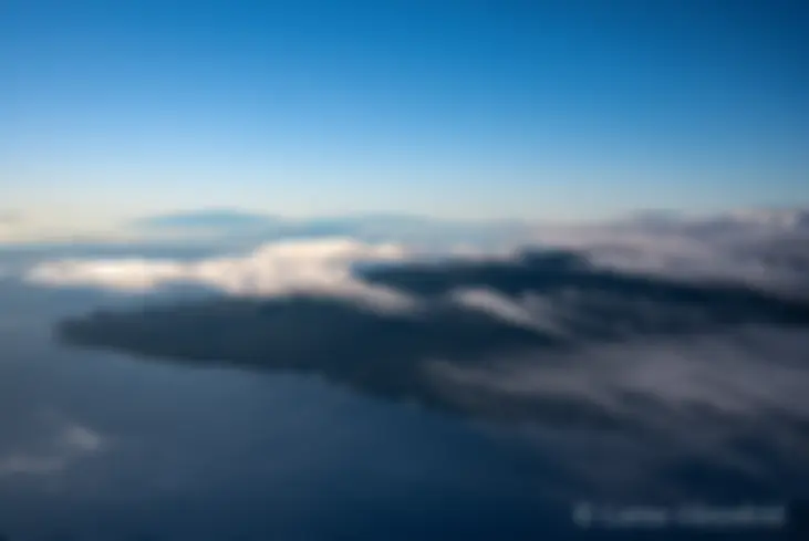 East Maui is in the foreground and the north end of the Big Island is in the distance as seen from 9,000 feet in the early morning . . .
