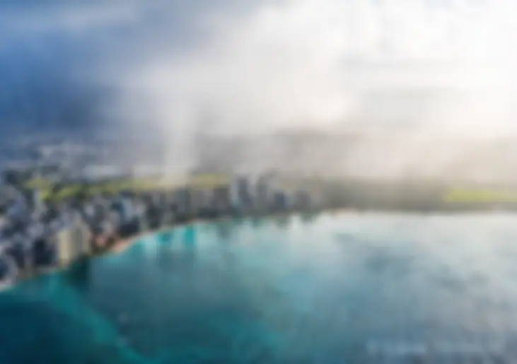 A morning shower on land, with clear skies and blue water off shore . . .